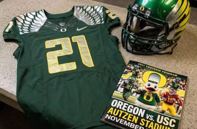 Gemini AI-created image of a 2011-era University of Oregon American football jersey 21 jersey, without a name on it, and a matching period-correct helmet, the program cover appropriate to the era and team.